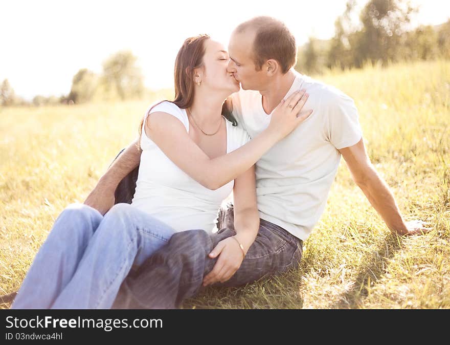 Happy young couple spending time outdoor on a summer day at sunset