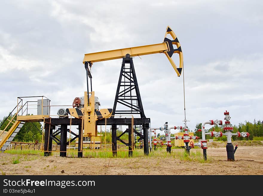 Extraction of oil. pump jack and oil well. Western Siberia. Russia.