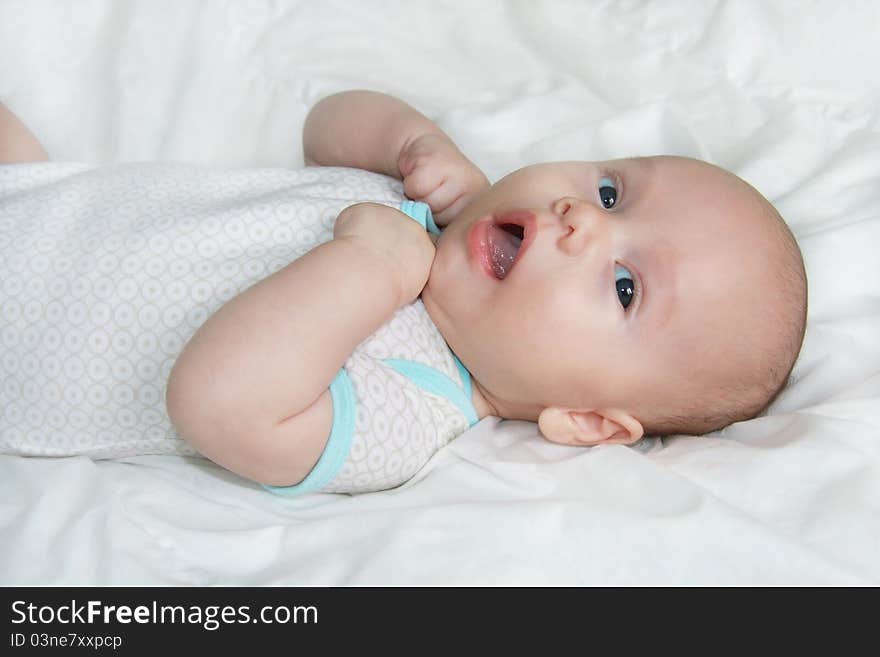 Beautiful baby lying on a bed