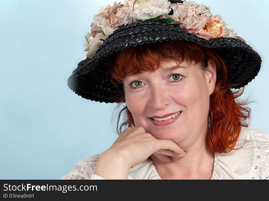 A portrait of a beautiful mature woman with red Hair smiling. A portrait of a beautiful mature woman with red Hair smiling