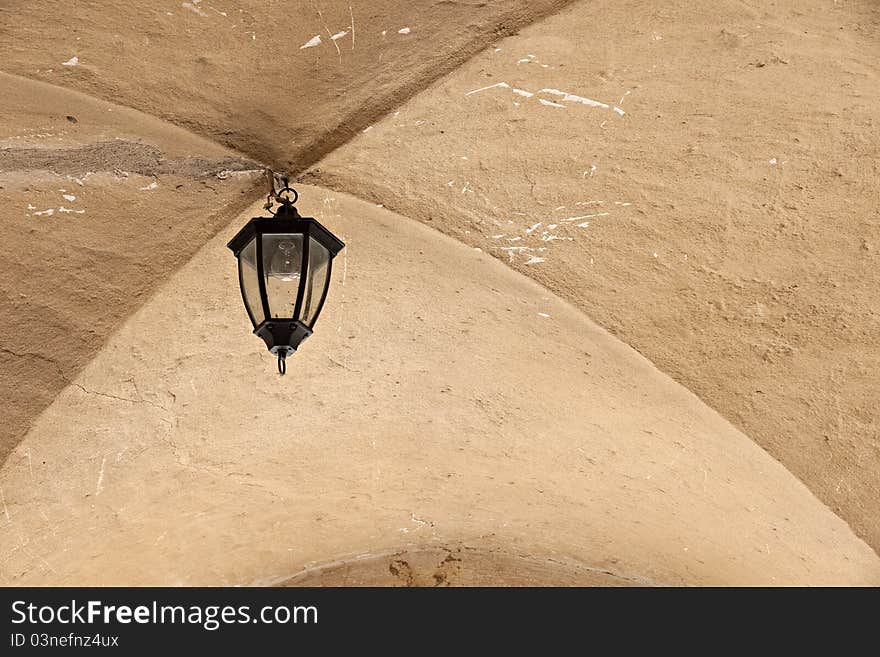 Old lantern in archway in medieval castle. Jaunpils.Latvia. Old lantern in archway in medieval castle. Jaunpils.Latvia.