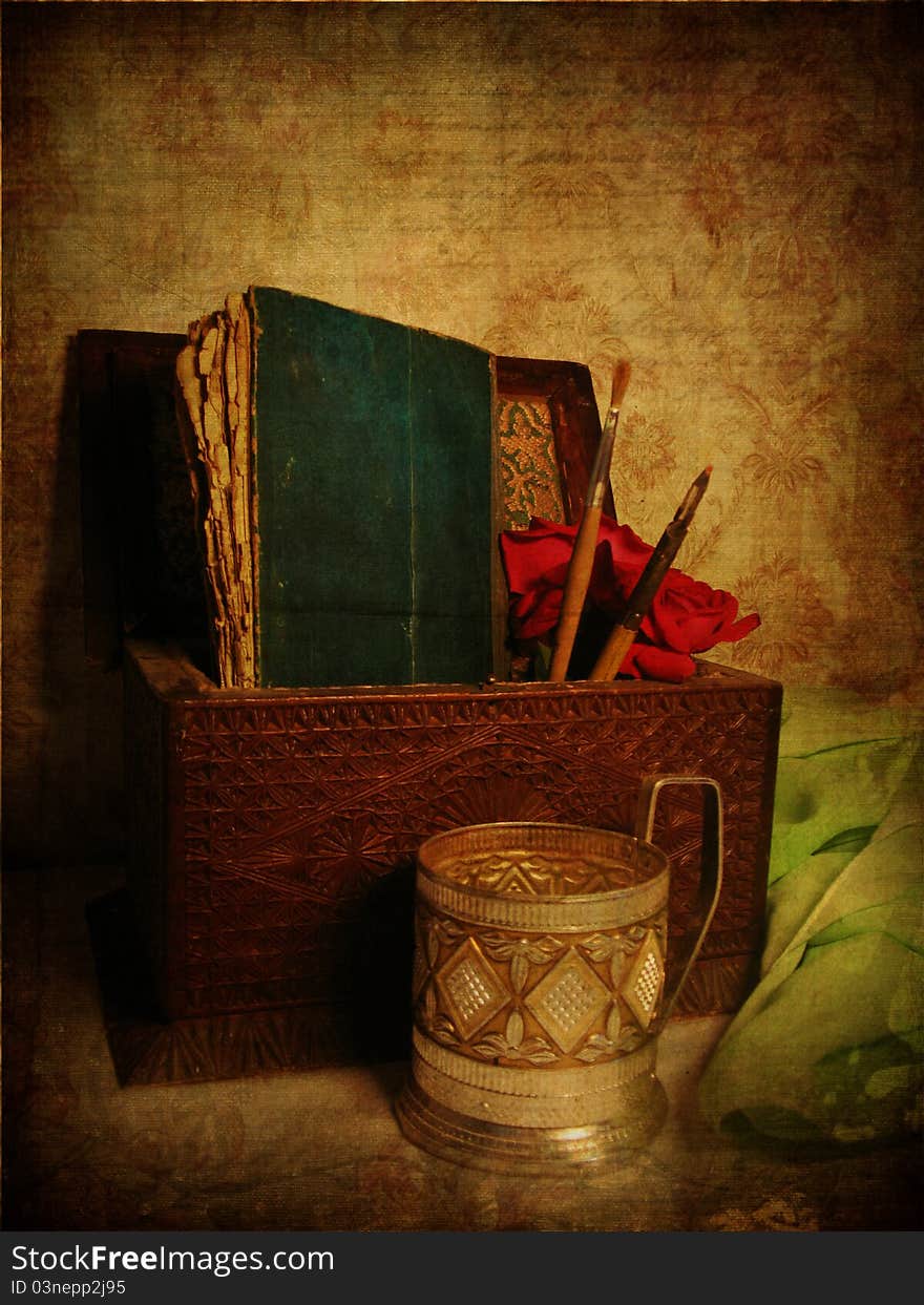 Vintage postcard with grunge background, lily, brush, pen, glass-holder, old book and box