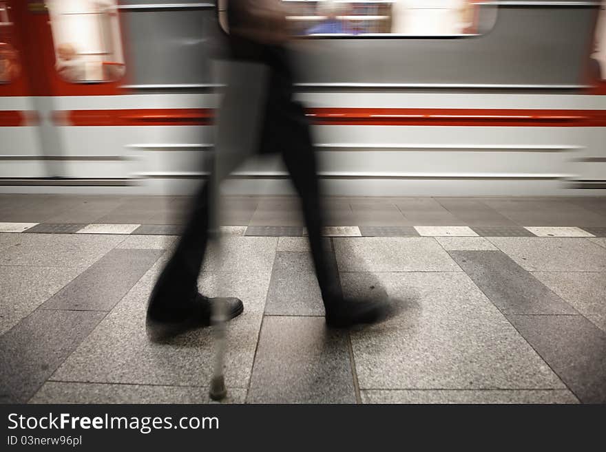 Old man is going to subway - blurred motion