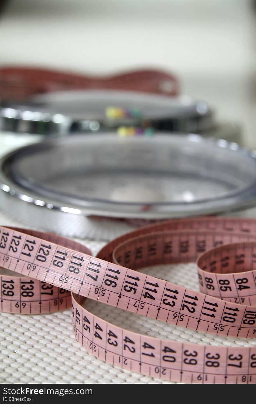 Tape measure and weight to weigh people. Tape measure and weight to weigh people