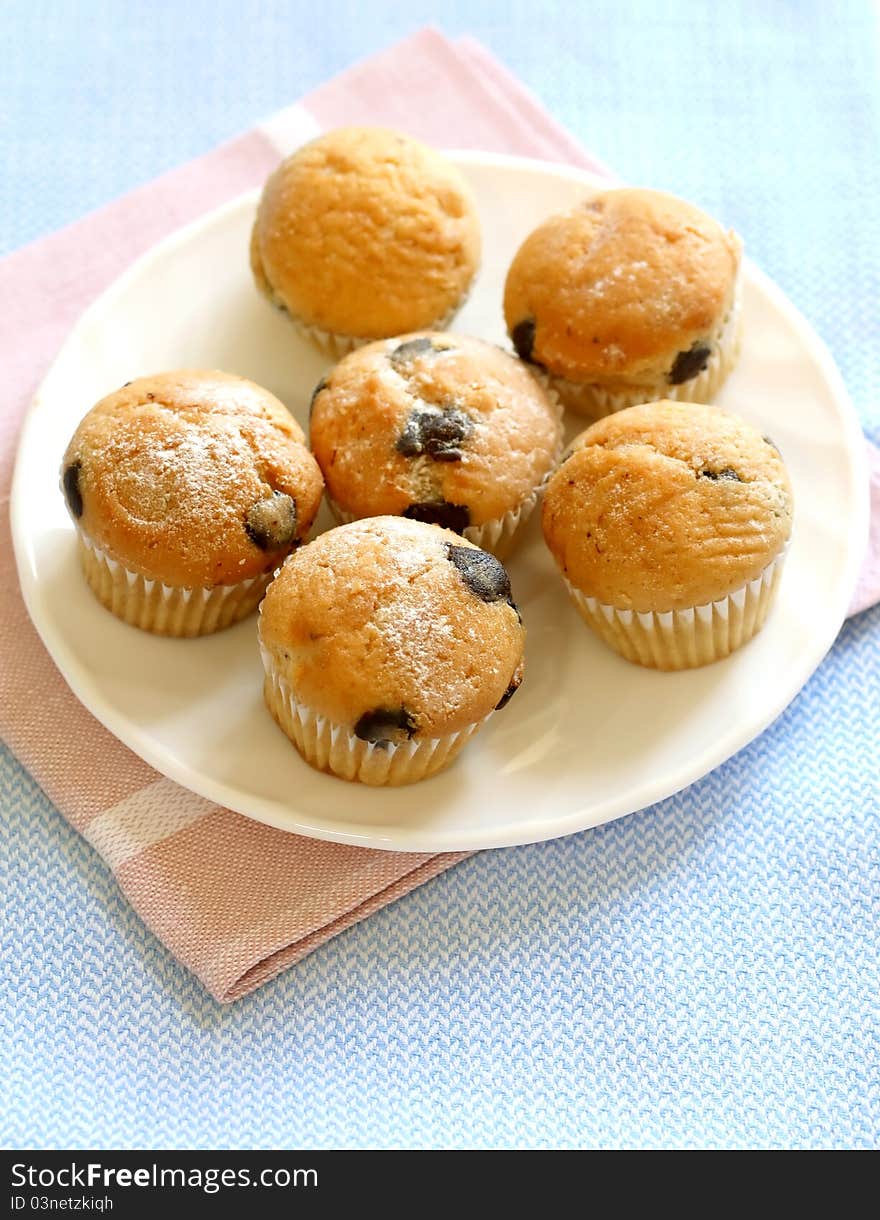 Muffin with chocolate on plate