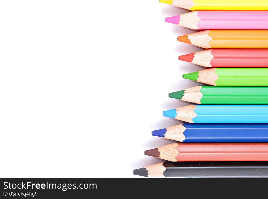 Close up of color pencils with different color over white background