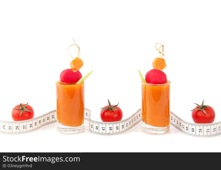 Fresh vegetable juice with garden radish and tape measure's waves on white background. Fresh vegetable juice with garden radish and tape measure's waves on white background