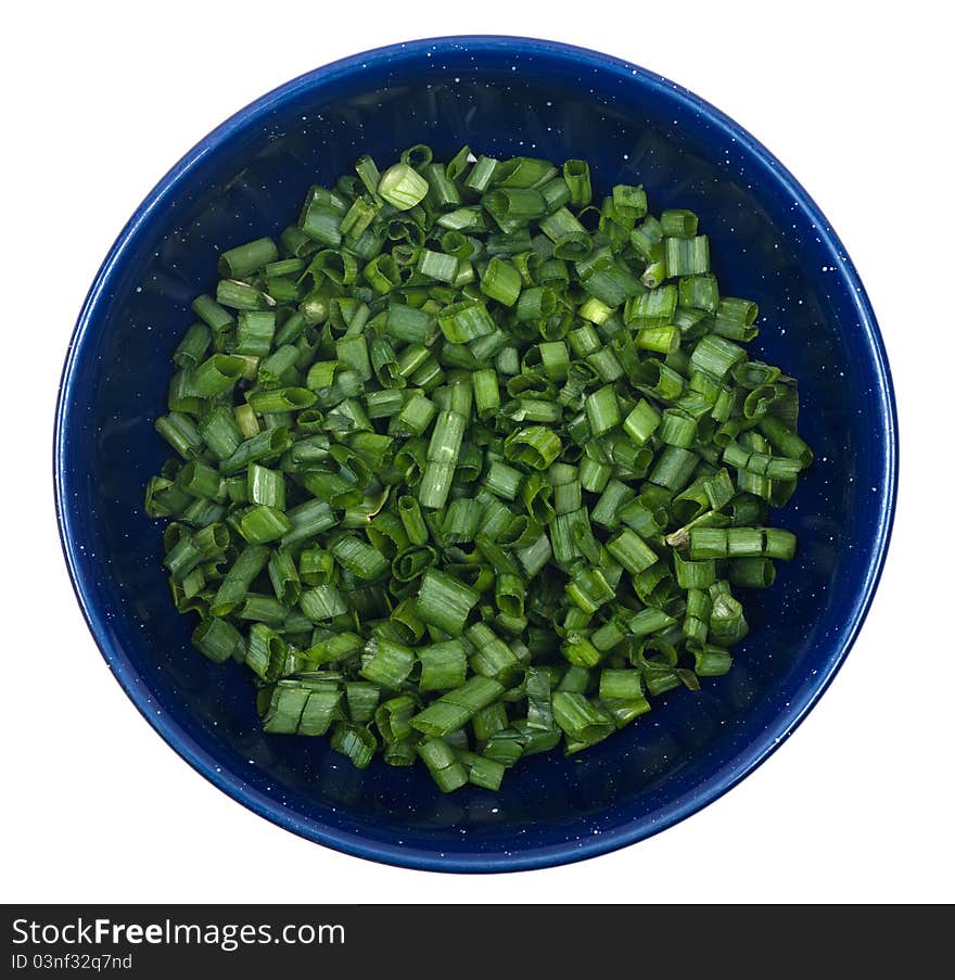 Studio shot of diced green onions in bowl on white background