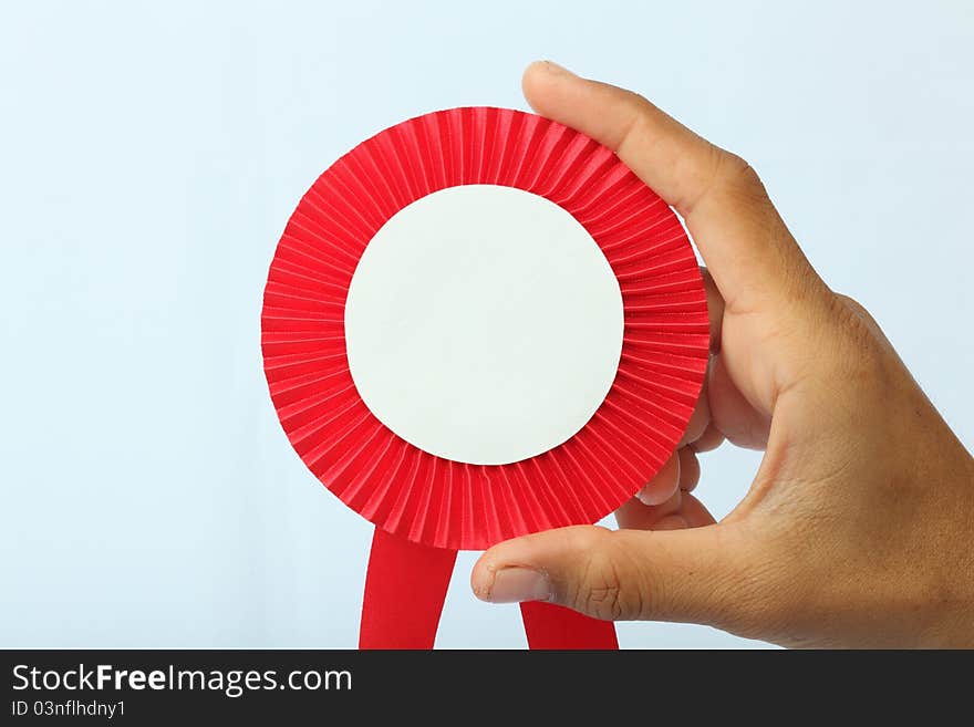 Reward red sign in a hand on white background. Reward red sign in a hand on white background