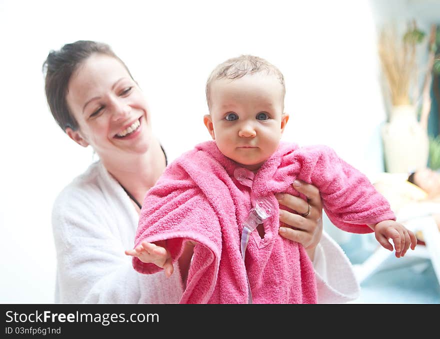 Young family with baby having fun in the swimming pool. Young family with baby having fun in the swimming pool.