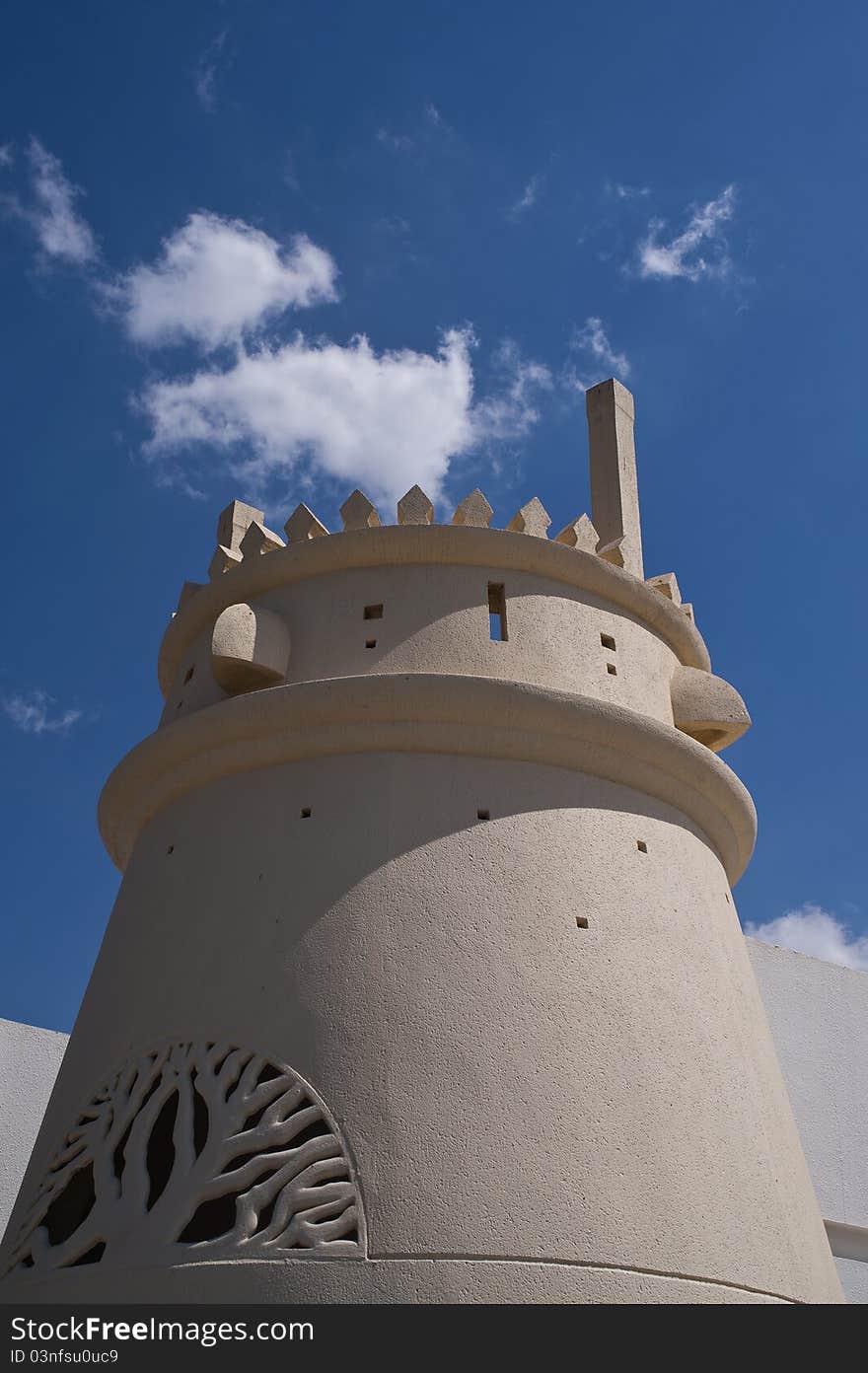 View of an Arabian Castle Turret under vivid bright blue cloudy sky in the UAE. View of an Arabian Castle Turret under vivid bright blue cloudy sky in the UAE
