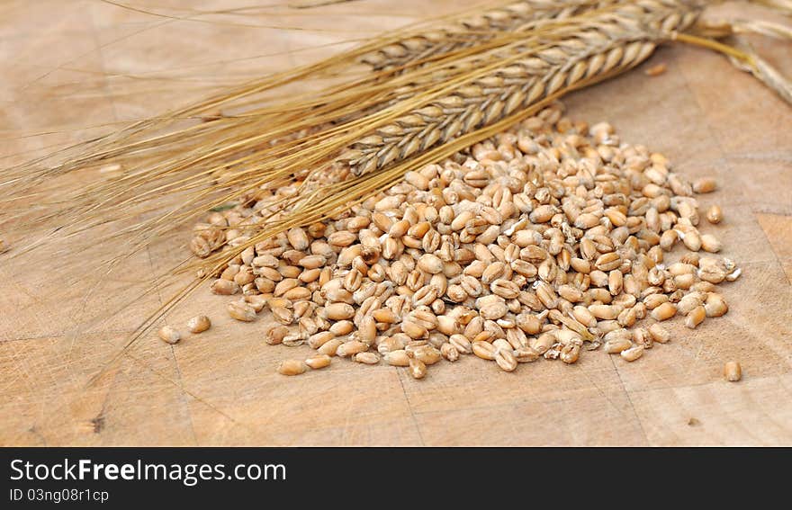 Cereal grains on wooden board