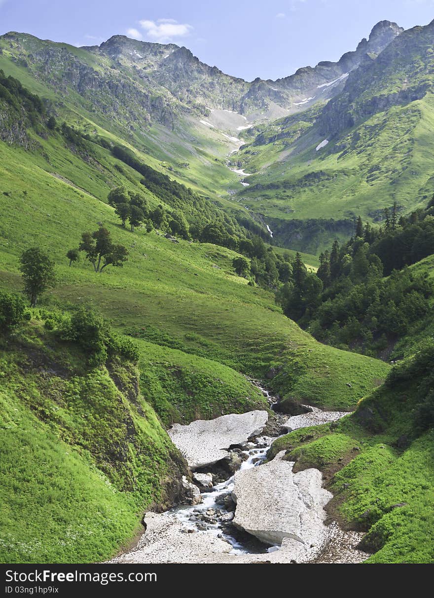 View of mountain gorge with rough stream