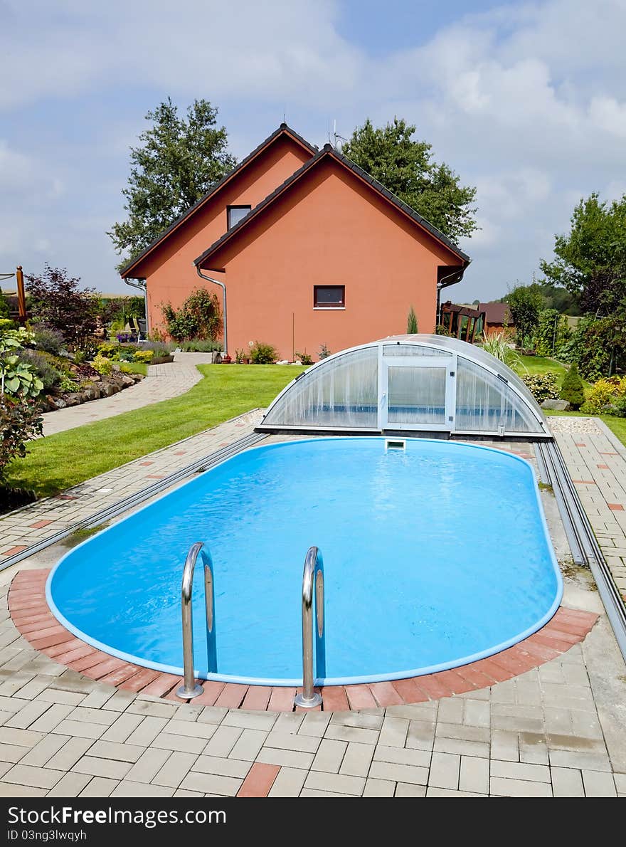 The pool with the garden and the house