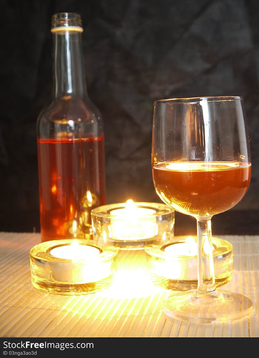 A small bottle of wine for one on a candle lit table. A small bottle of wine for one on a candle lit table