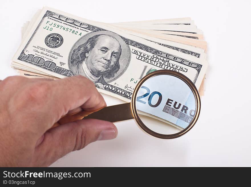 Magnifying a hundred dollar bill with golden color lupe showing 20 euro bill on white background. Magnifying a hundred dollar bill with golden color lupe showing 20 euro bill on white background