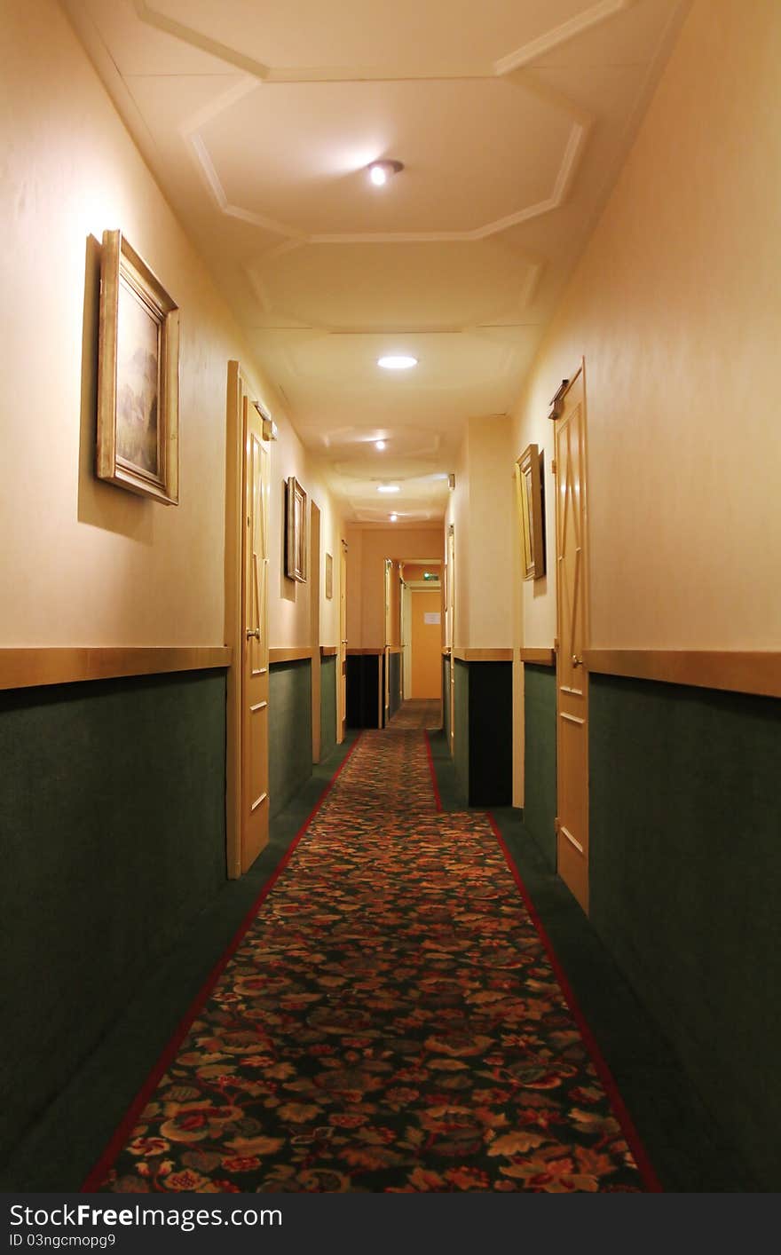 Hotel corridor with lamps on the ceiling