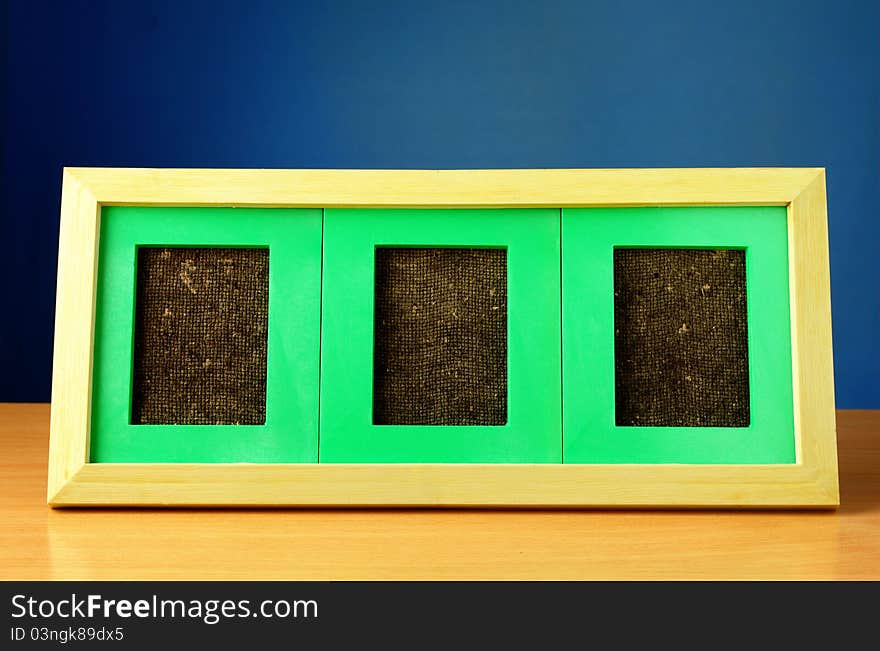 Rectangular frame on the table and a blue background. Rectangular frame on the table and a blue background