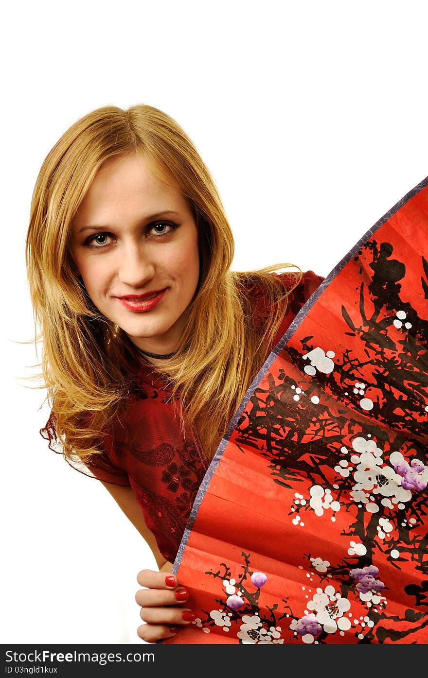 Sharming woman in red dress on the white background and fan painted with cherry tree on it in the front. Sharming woman in red dress on the white background and fan painted with cherry tree on it in the front