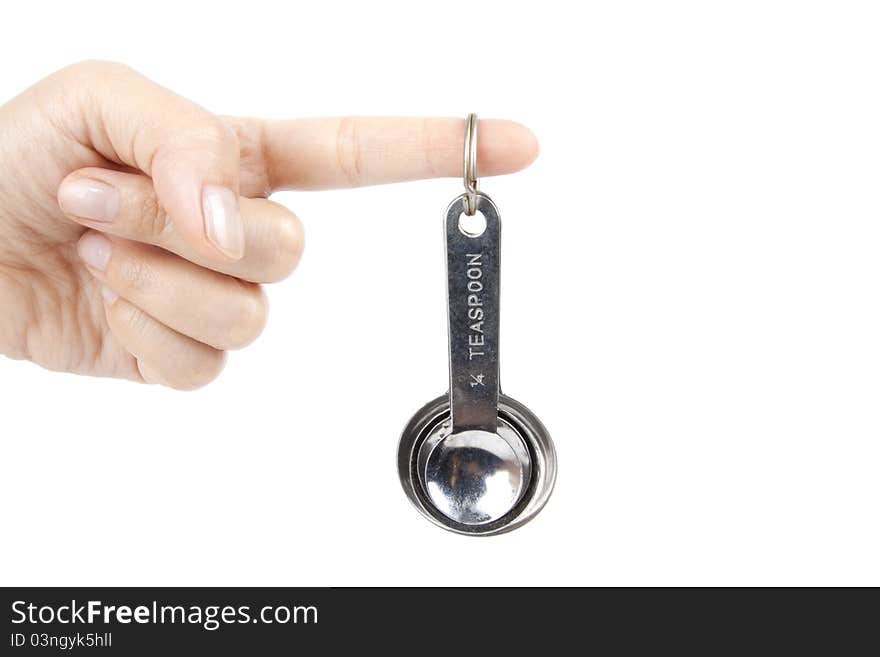 Female hand holding a set of silver table spoon. Female hand holding a set of silver table spoon.