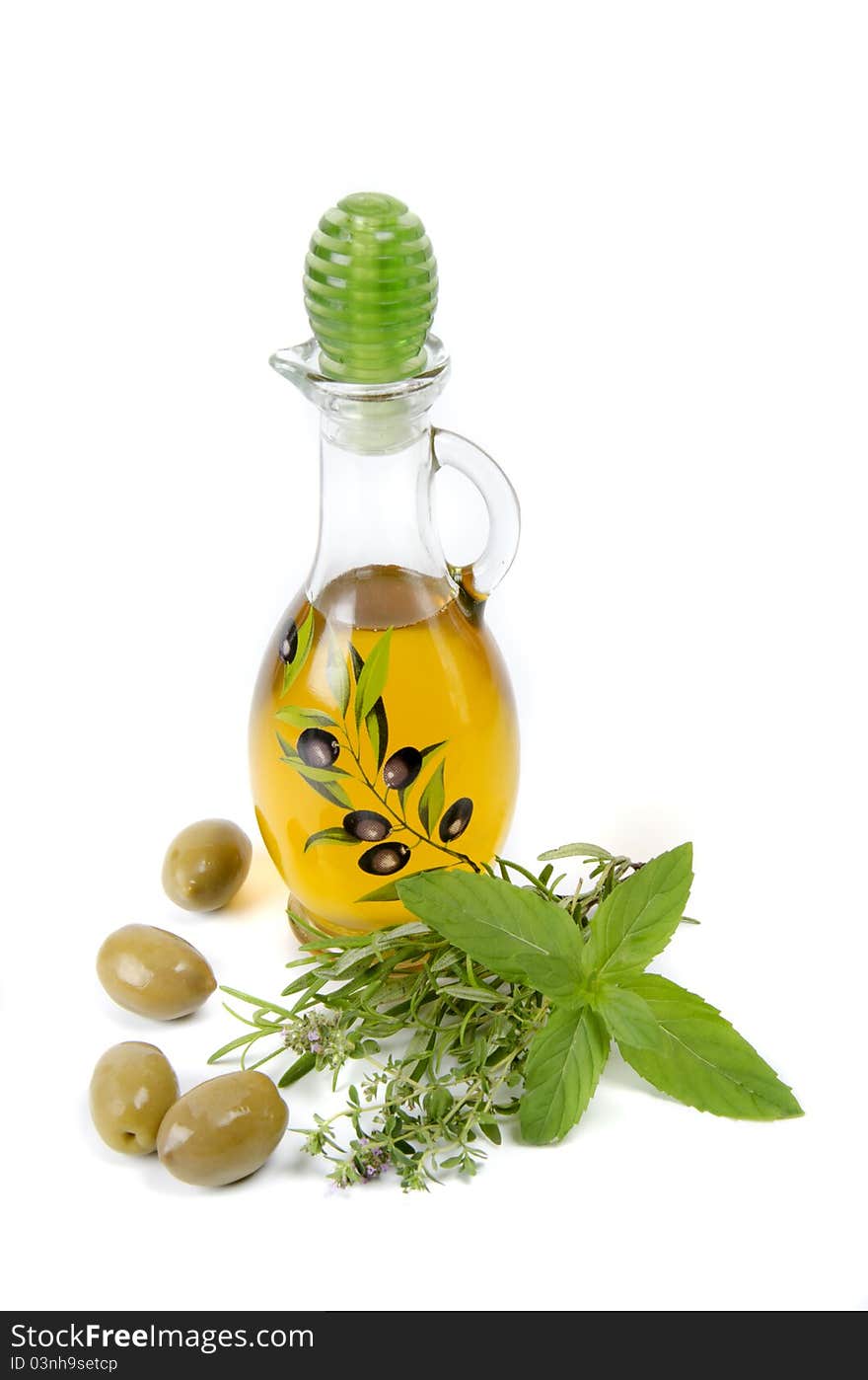 Oil in bottle and herbs on white background. Oil in bottle and herbs on white background