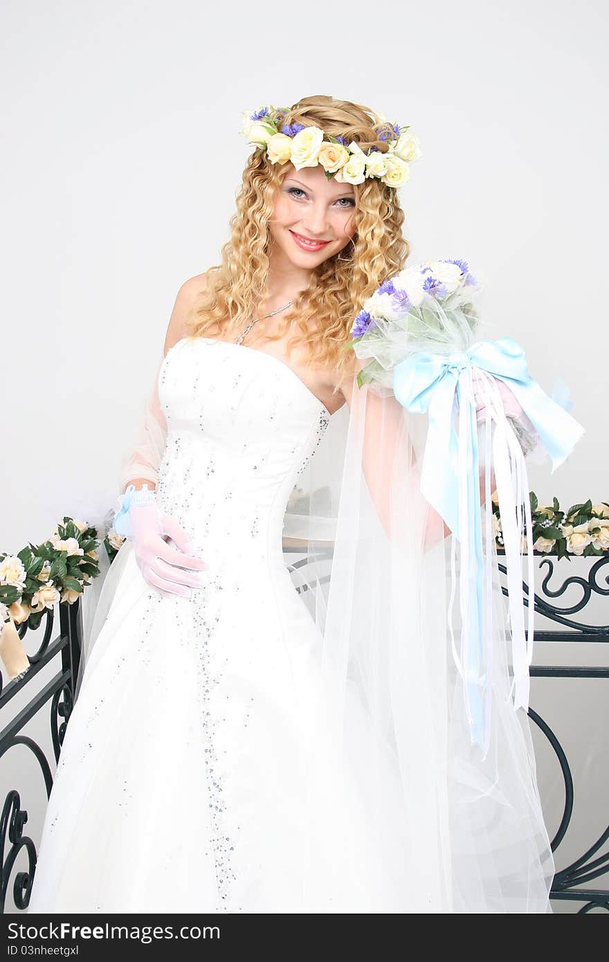 Bride posing in a studio on the wedding day. Bride posing in a studio on the wedding day