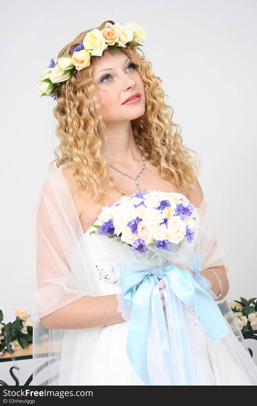 Bride posing in a studio on the wedding day. Bride posing in a studio on the wedding day