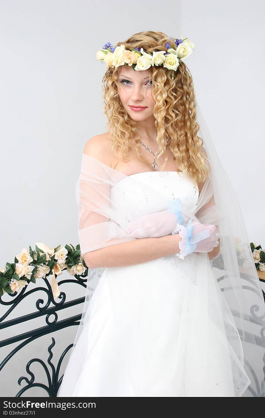 Bride posing in a studio on the wedding day. Bride posing in a studio on the wedding day