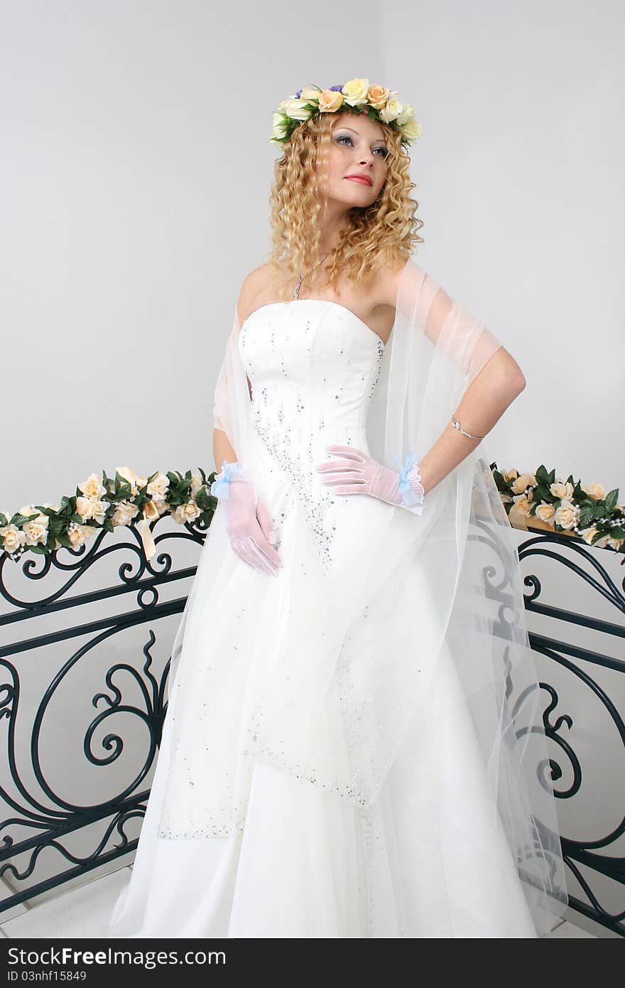 Bride posing in a studio on the wedding day. Bride posing in a studio on the wedding day