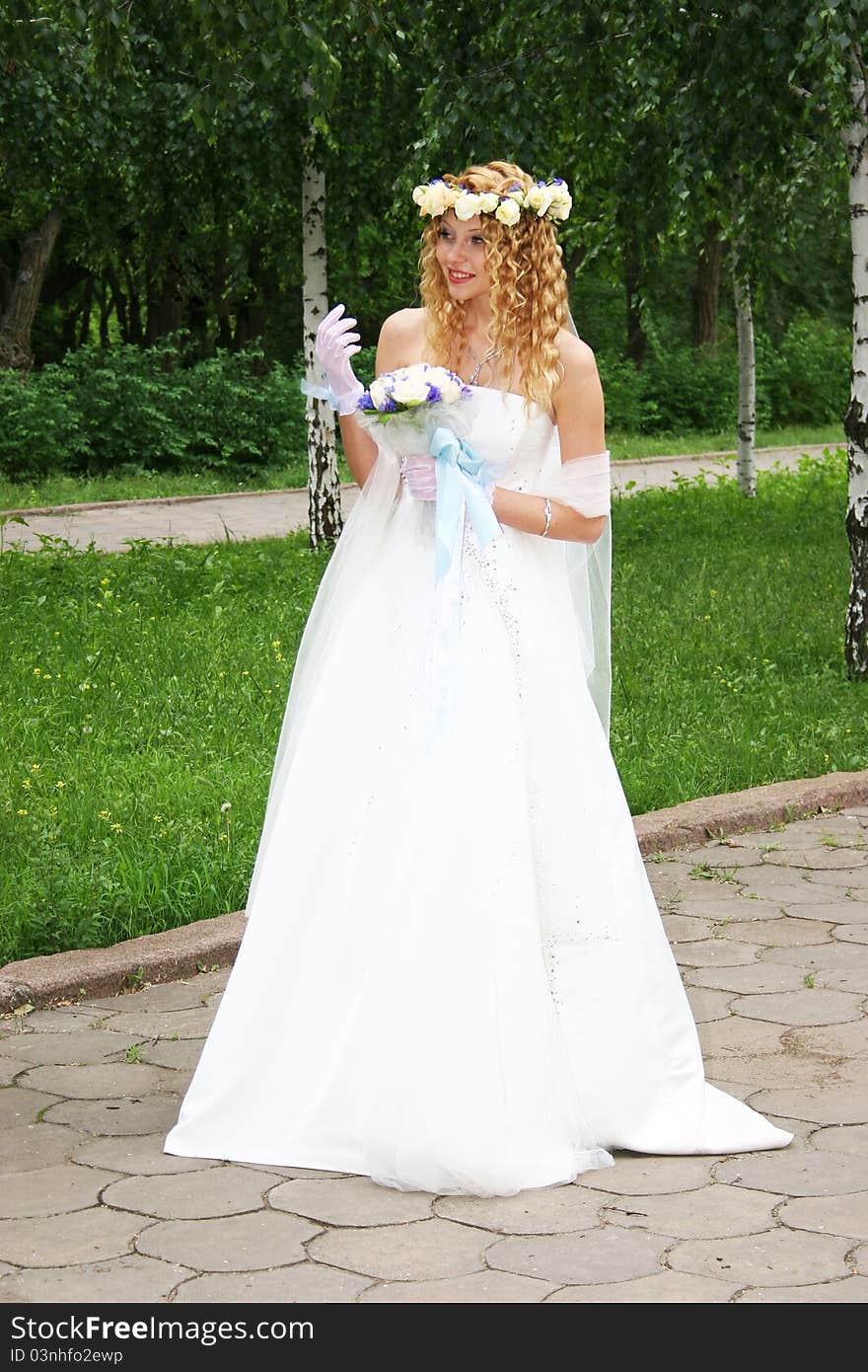 Bride posing outdoors in a park. Bride posing outdoors in a park