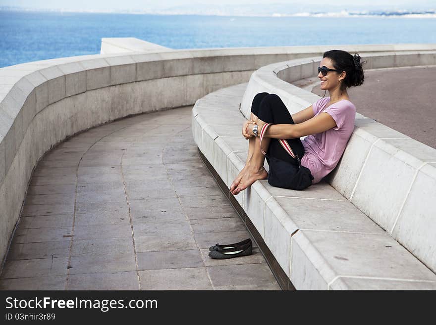 Woman relaxing in front of the beach on holidays. Woman relaxing in front of the beach on holidays