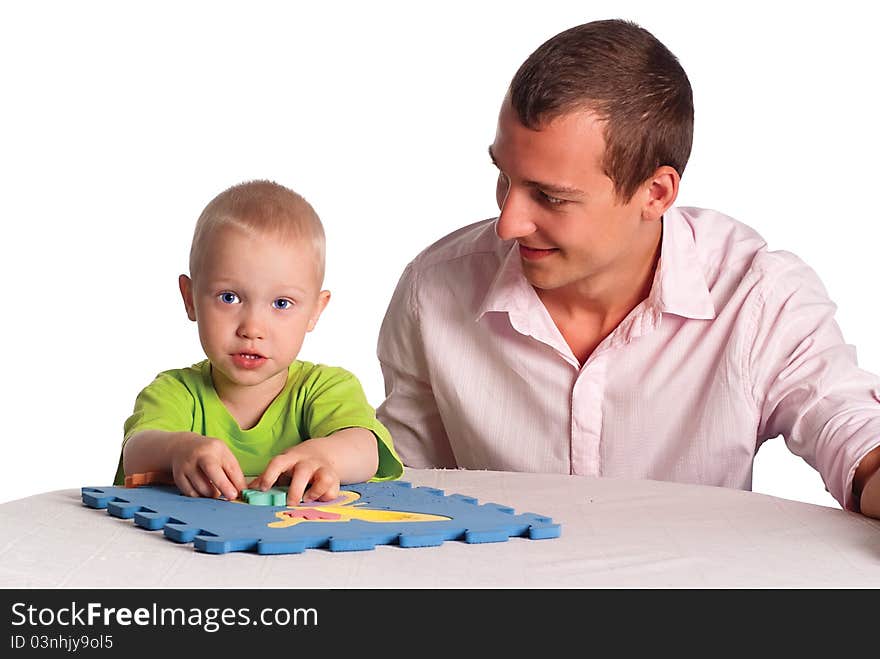 Smart dad and his son play at table. Smart dad and his son play at table