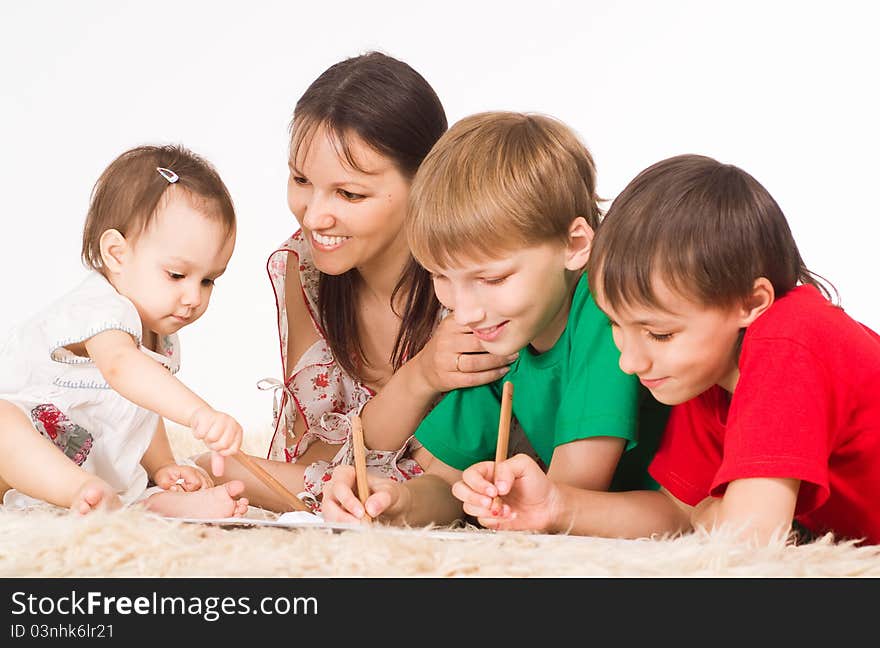 Mom and her children drawing on carpet. Mom and her children drawing on carpet