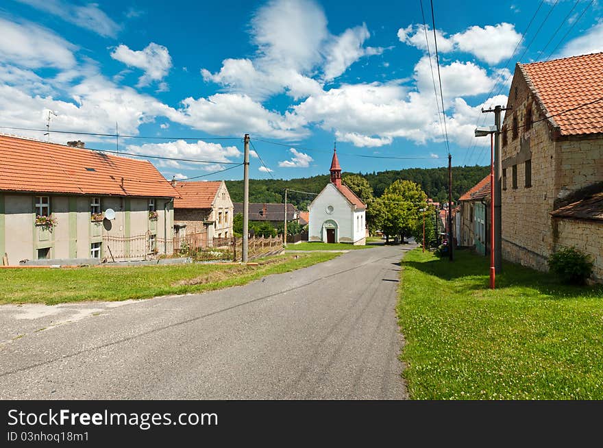 A small chapel by the road in the center of a small village. A small chapel by the road in the center of a small village.