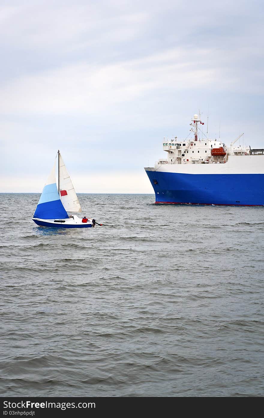 Yacht and trade ship on the sea