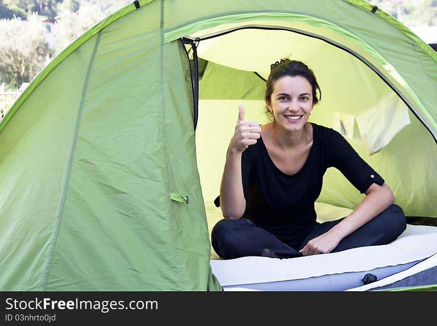 Woman sitting in a green tent. Woman sitting in a green tent