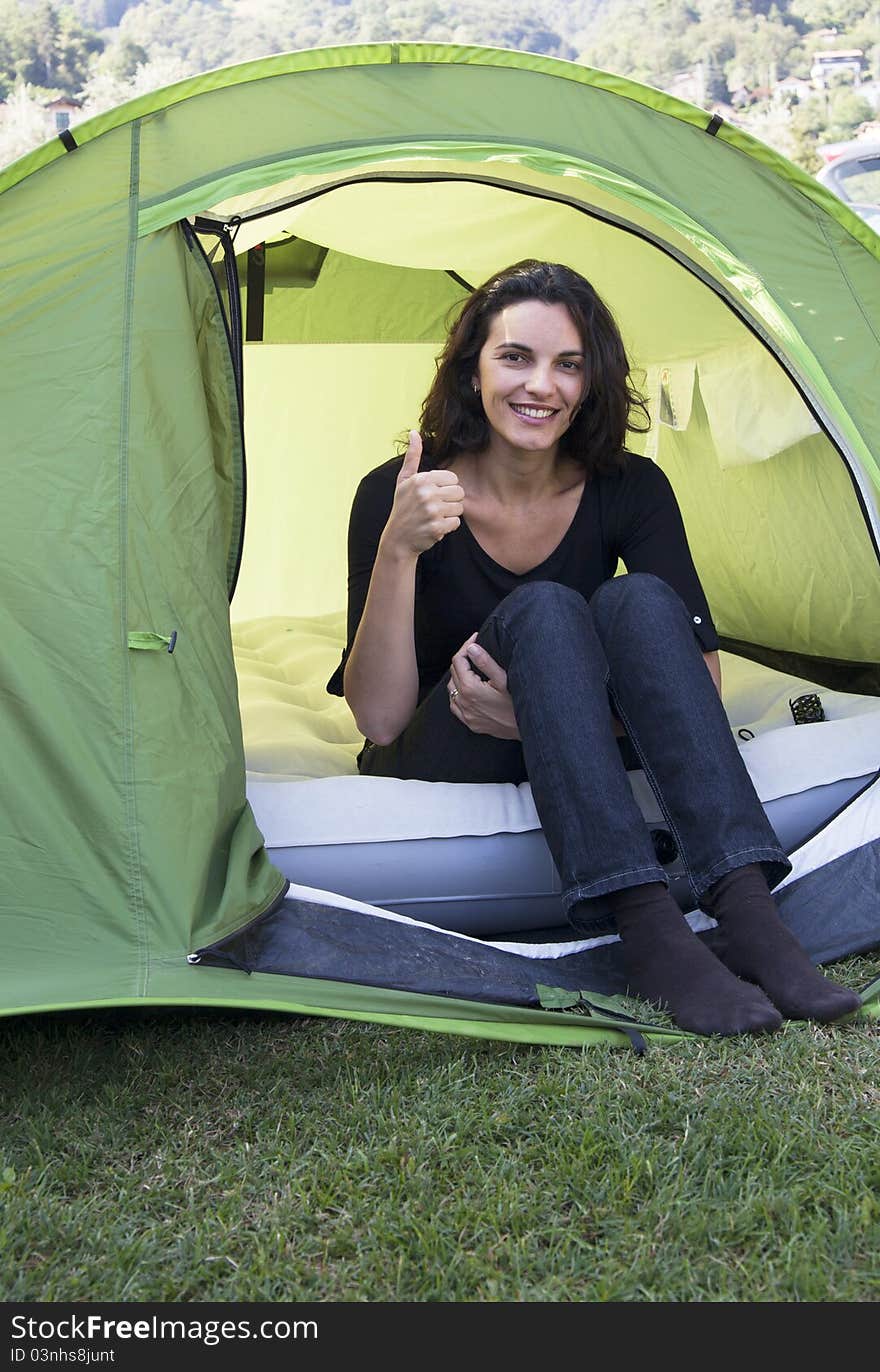 Woman sitting in a green tent. Woman sitting in a green tent