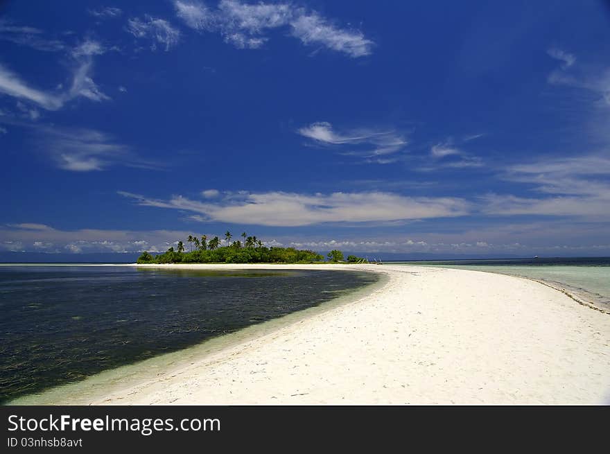 Narrow sand strip leading to isolated tropical island. Narrow sand strip leading to isolated tropical island