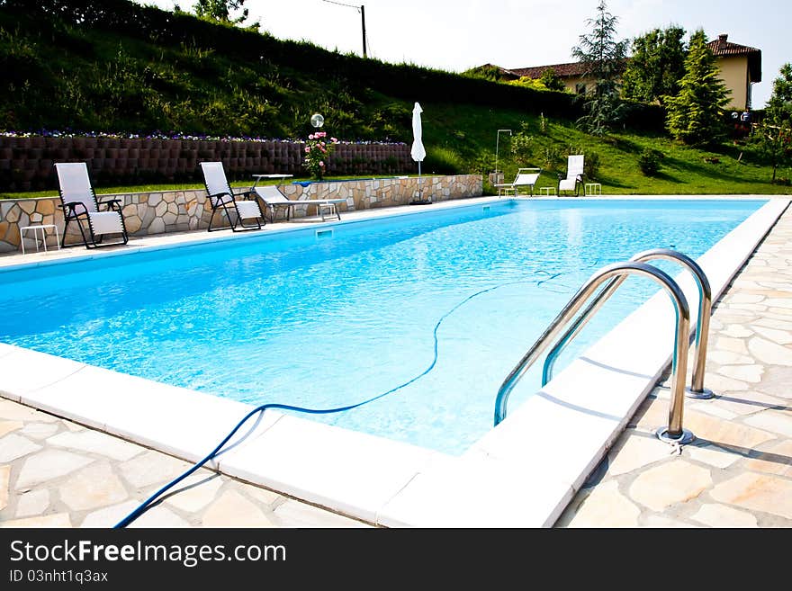 Swimming pool of an Italian beauty farm in the middle vineyards, Monferrato area, Piemonte region. Swimming pool of an Italian beauty farm in the middle vineyards, Monferrato area, Piemonte region.