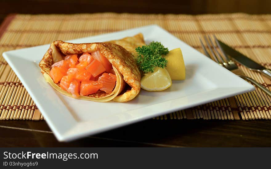 Russian pancakes with salt salmon fish with lemon. Russian pancakes with salt salmon fish with lemon