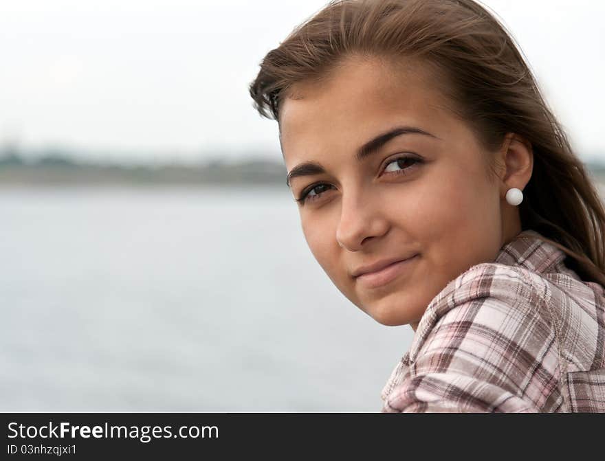 Portrait of a beautiful girl on the background of the horizon