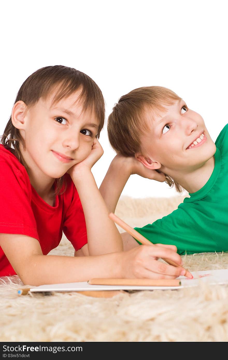 Two cute boys drawing on a carpet. Two cute boys drawing on a carpet