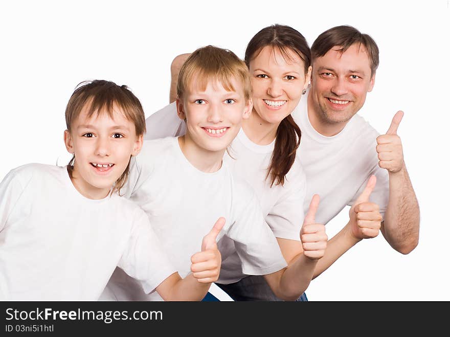 Pretty family in white clothes on a white. Pretty family in white clothes on a white