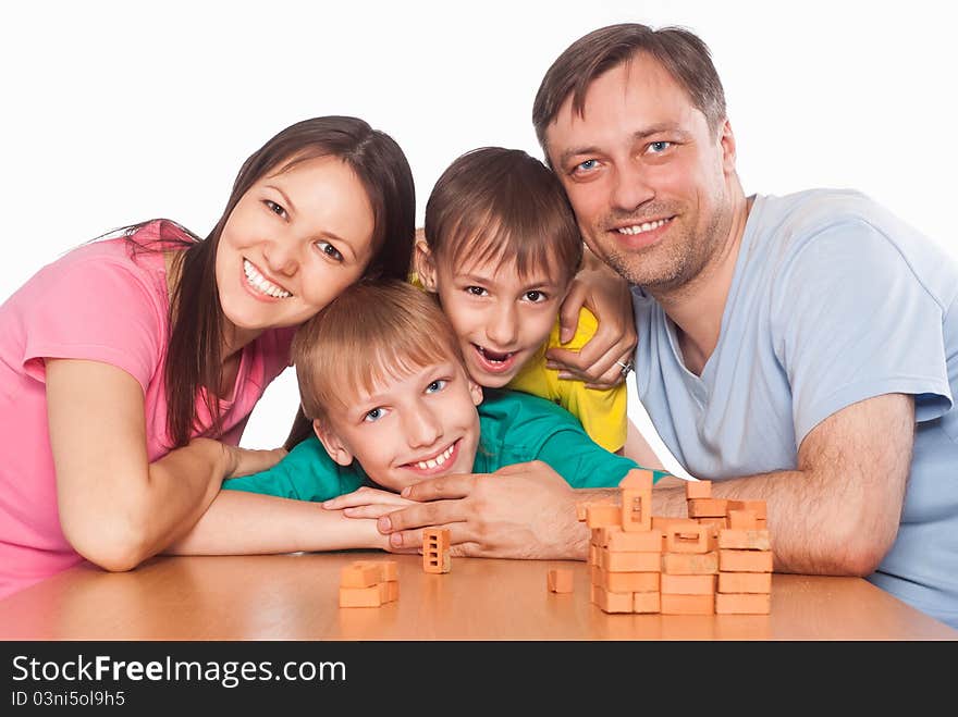 Nice family playing at table on white