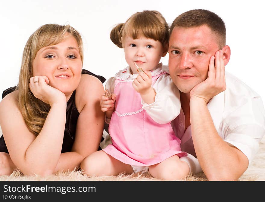 Nice family of a three playing on a carpet. Nice family of a three playing on a carpet