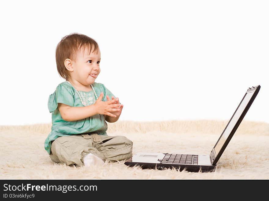 Cute little girl with laptop on capet. Cute little girl with laptop on capet