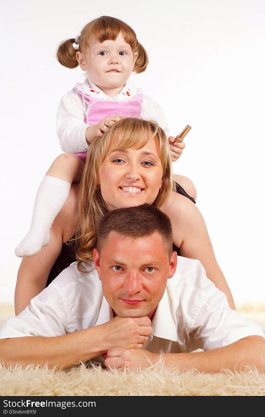 Nice family of a three playing on a carpet. Nice family of a three playing on a carpet