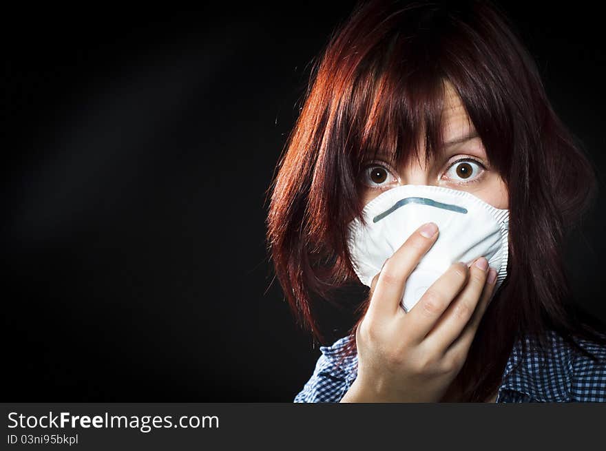 Girl wearing protective mask on black background