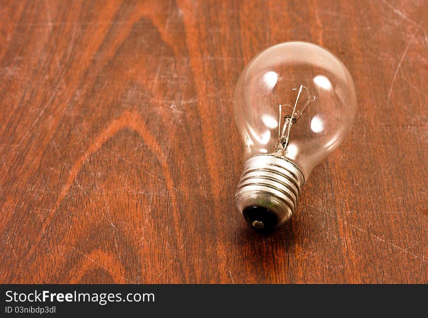 Light Bulb On Wooden Plate