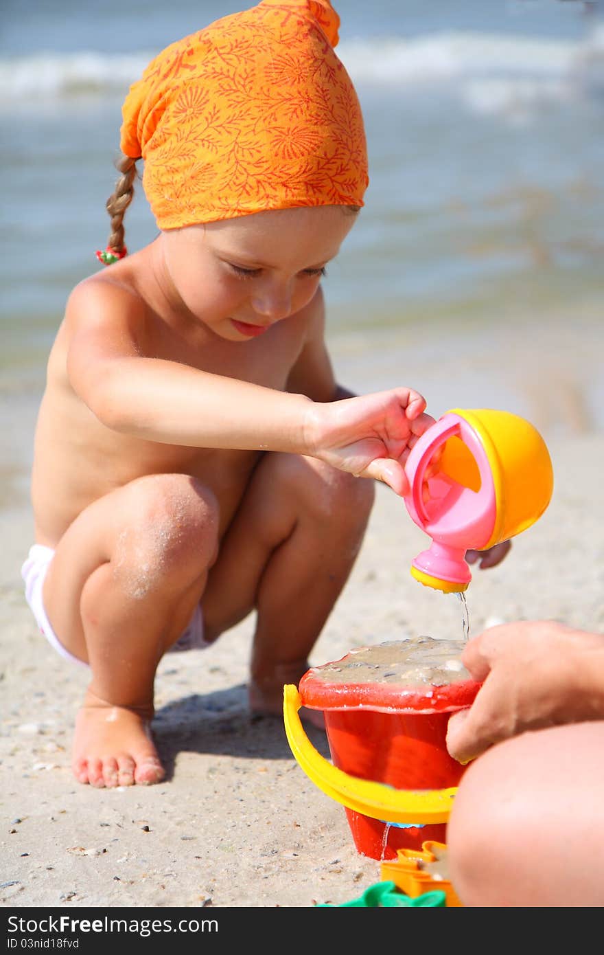 Cute girl playing with beach toys